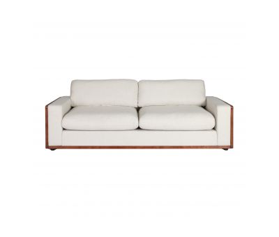 Modern sofa upholstered in cream fabric with rattan detail on side of arms