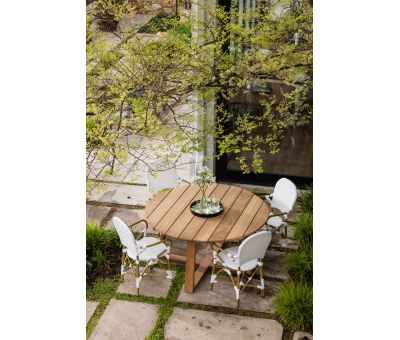 Round outdoor dining table in iroko