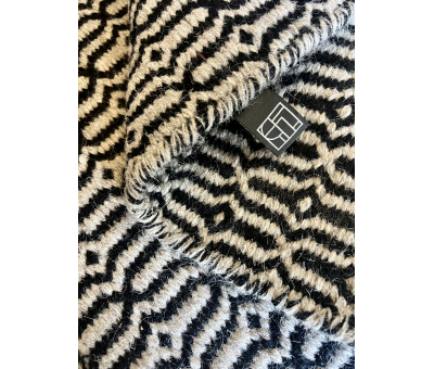 Block & Chisel stone coloured wool rug with black pattern detail