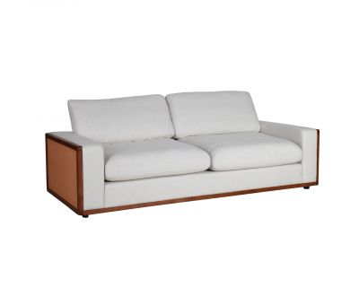 Modern sofa upholstered in cream fabric with rattan detail on side of arms
