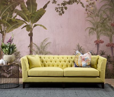 yellow upholstered sofa with buttoned back detail