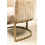 modern armchair in stone with brushed bronze metal base 