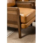 Modern armchair in leather with rattan inlay on arms