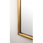 Gold framed mirror with ornate top