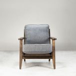 Modern armchair, wooden frame with light grey back and seat cushion