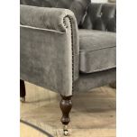 upholstered armchair with deep button detail and castors