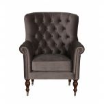 upholstered armchair with deep button detail and castors