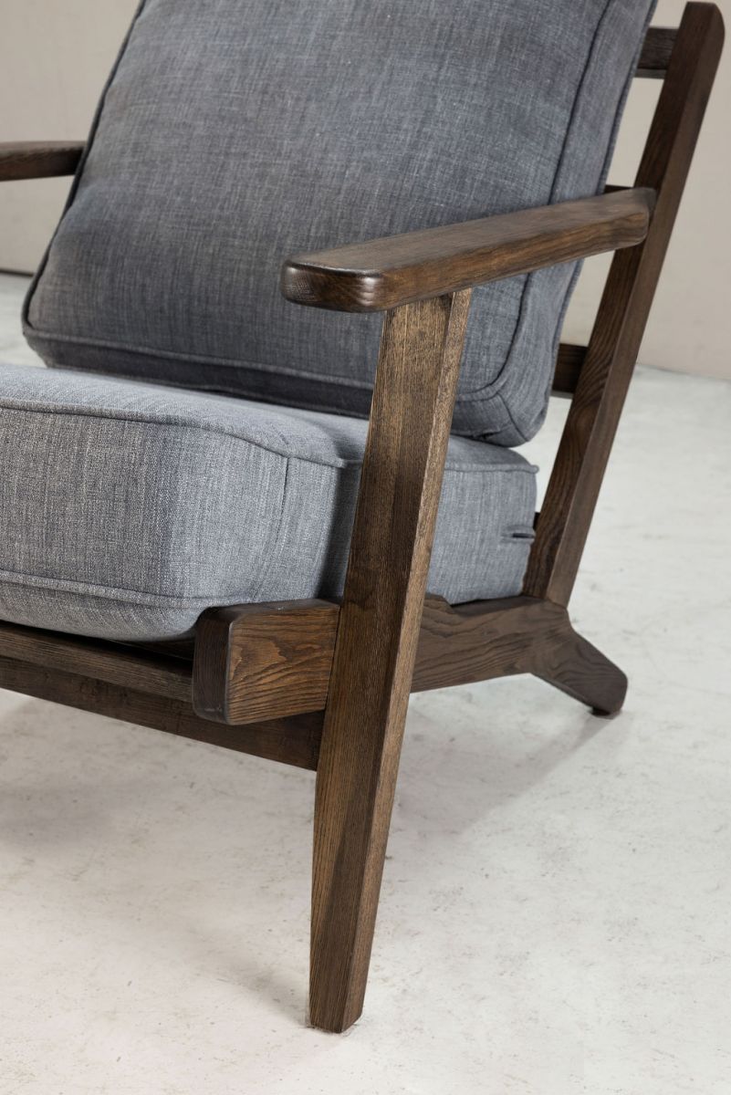 Modern armchair, wooden frame with light grey back and seat cushion