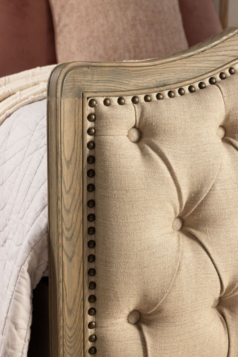 French style bed with deep button detail upholstered in linen