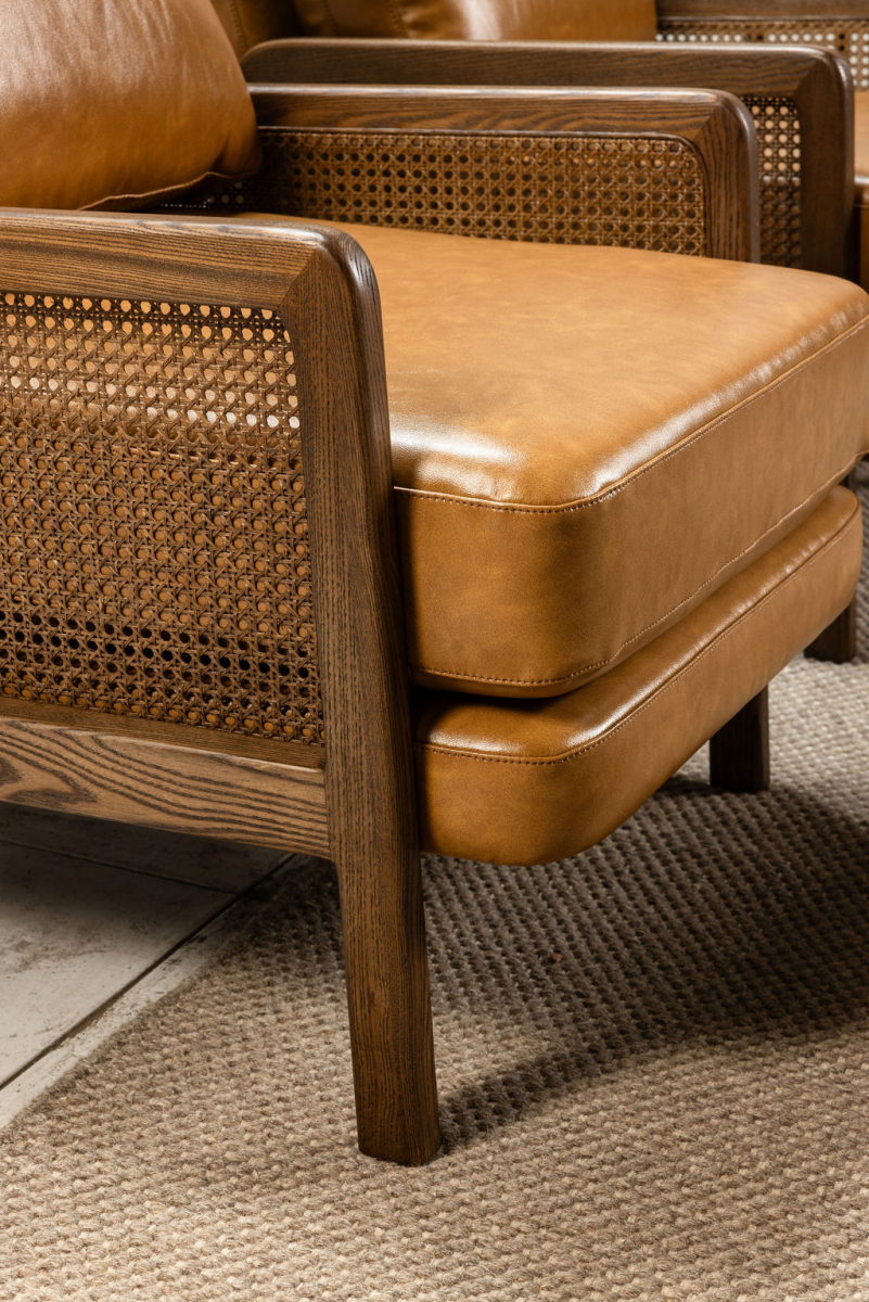 Modern armchair in leather with rattan inlay on arms