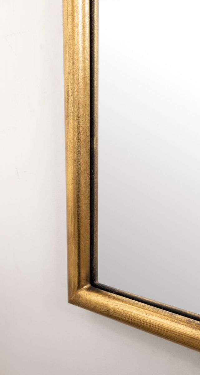 Gold framed mirror with ornate top