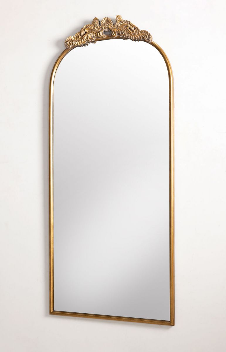 Gold framed mirror with ornate top