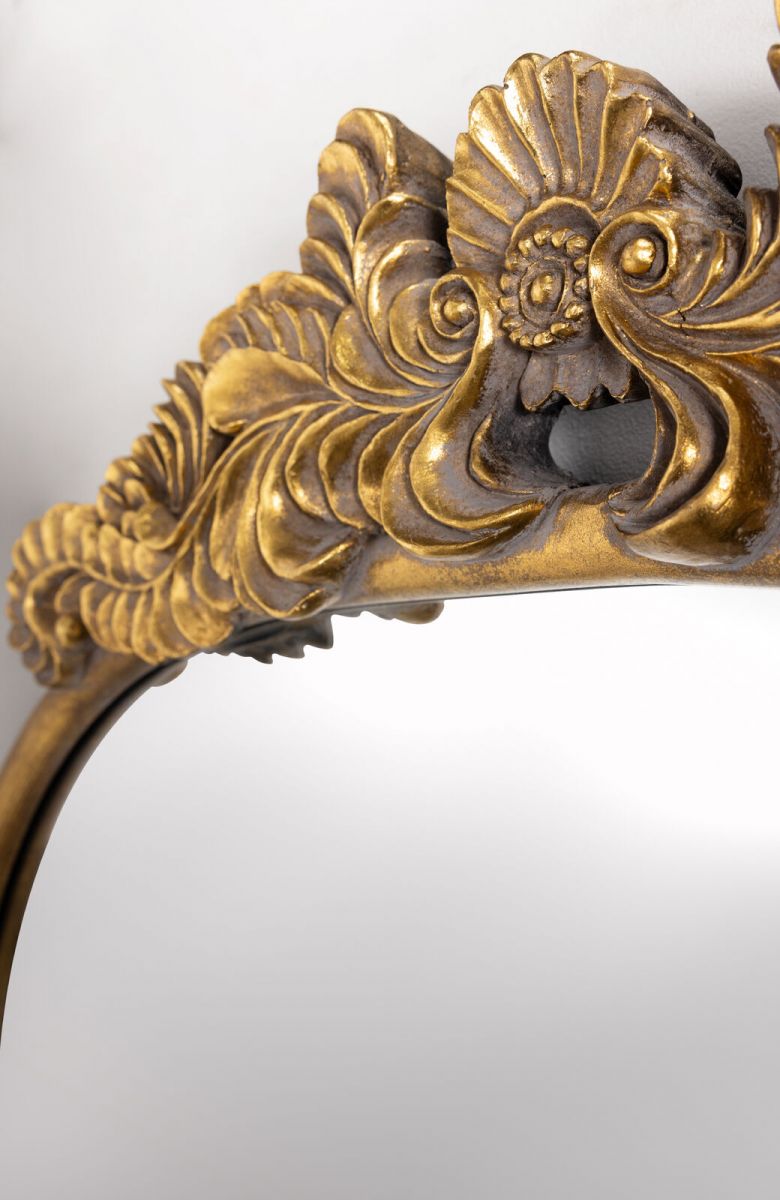 Gold framed mirror with ornate top