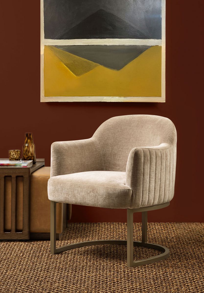 modern armchair in stone with brushed bronze metal base 