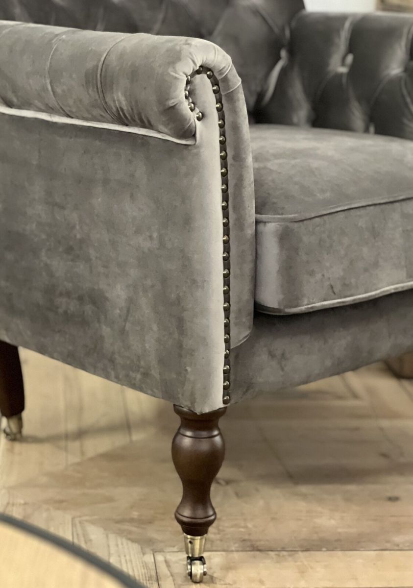 upholstered armchair with deep button detail and castors