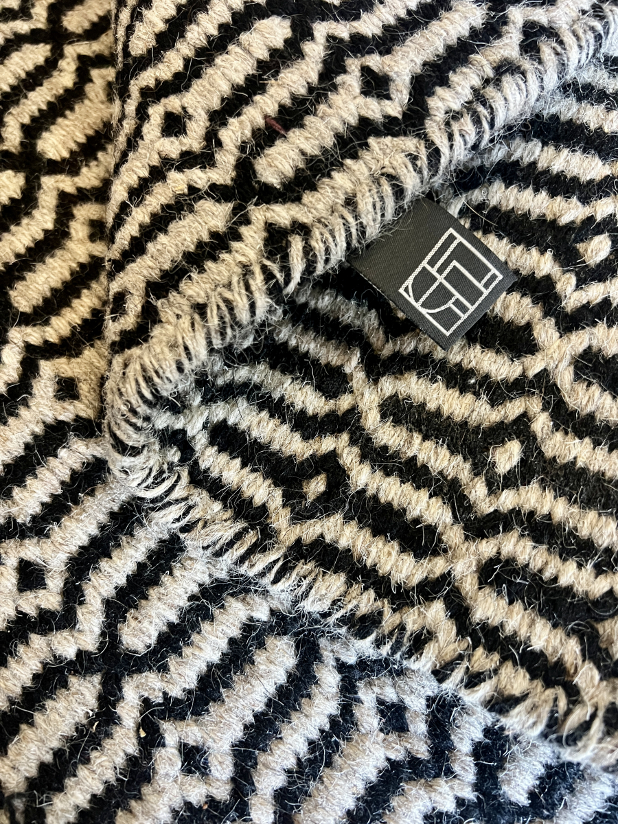 Block & Chisel stone coloured wool rug with black pattern detail